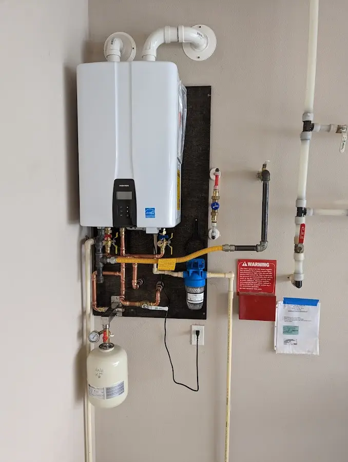 Professional plumber installing copper piping in a Half Moon Bay home